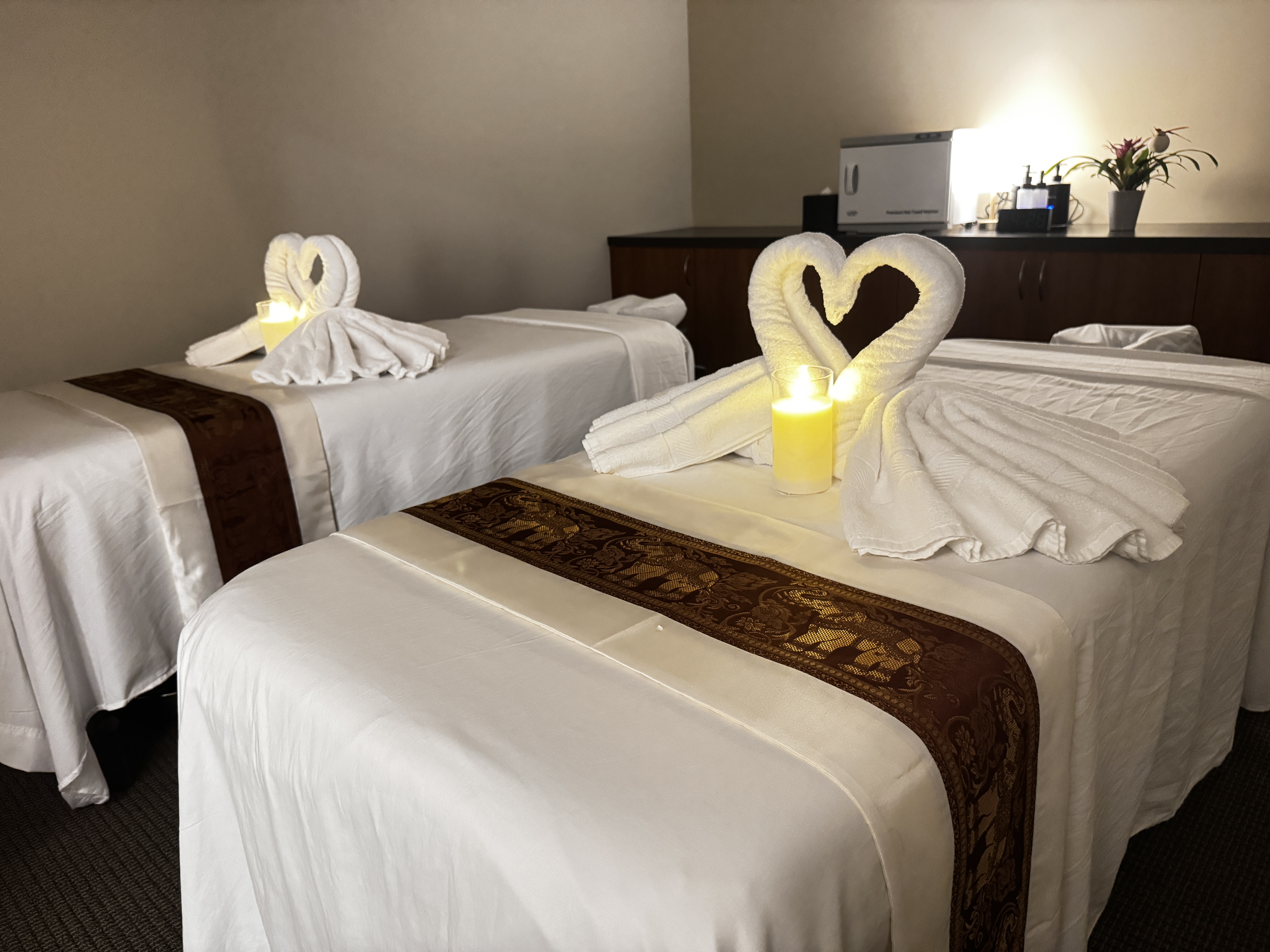 Spacious couples massage room with dual massage tables